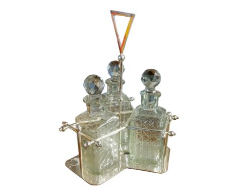 An Art Deco style silver plated three bottle tantalus, shaped angular base, 35cm high