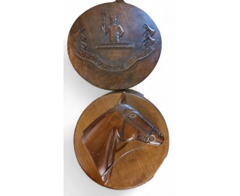 Treen - a circular wall plaque, carved in relief with a horses head, 29cm diam;&nbsp; &nbsp;another, carved with crest, Honor