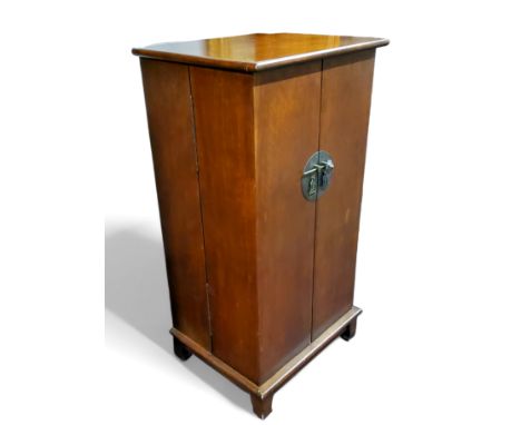 A&nbsp; mahogany cabinet, in in the Oriental manner, circular lock plate, opening to reveal multiple pigeon holes, bracket fe