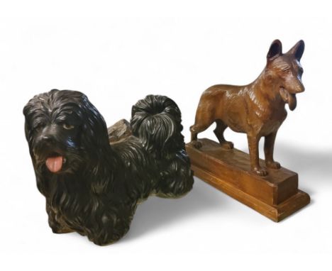 An early 20th century carved German Shepherd, rectangular plinth, 31.5cm high;&nbsp; &nbsp;a pottery Shih Tzu terrier (2)