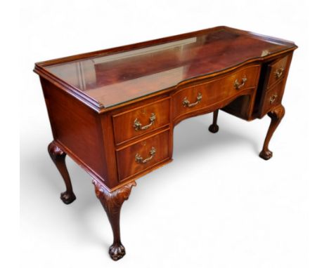 A Chippendale Revival flamed mahogany dressing table, dished top holding protective glass top, one long drawer to frieze, fla