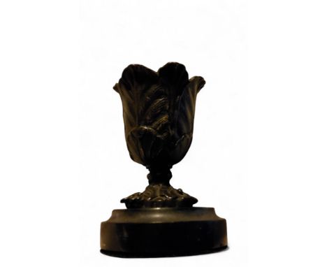 A Regency bronze table vesta, lofty lotus moulded sconce, circular turned marble base, 9cm high, c.1815