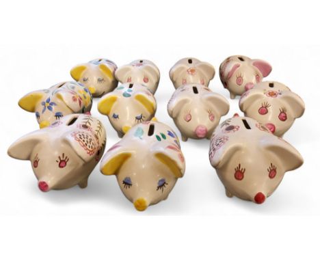 Eleven Arthur Wood novelty money boxes, in the form of comical pigs, standing on all fours, with large ears, painted with sty