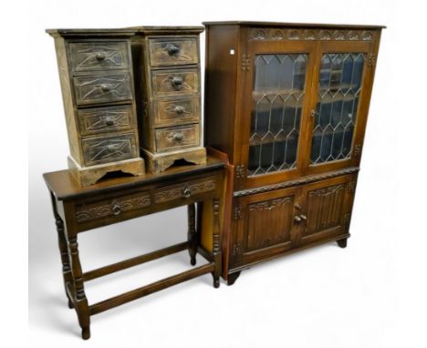 An Old Charm type astrigal glazed bookcase, linen fold details; a pair of Aboriginal inspired bedside cabinets; hall table (3