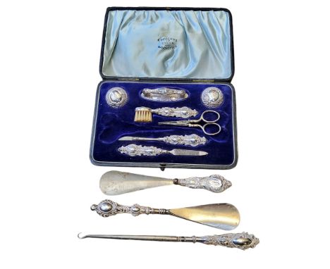 An Adie &amp; Lovekin silver dressing table set in original presentation box; a silver hafted button hook, two shoe horns (dr