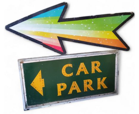 A substantial sign written fairground car park sign in yellow and green; a multicoloured fairground arrow, the arrow measures