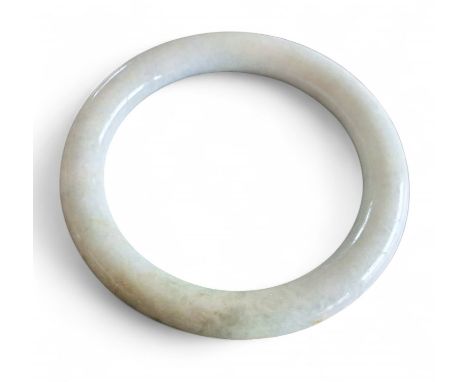 A mottled jade bangle, 82.5mm, inner measurement 62mm