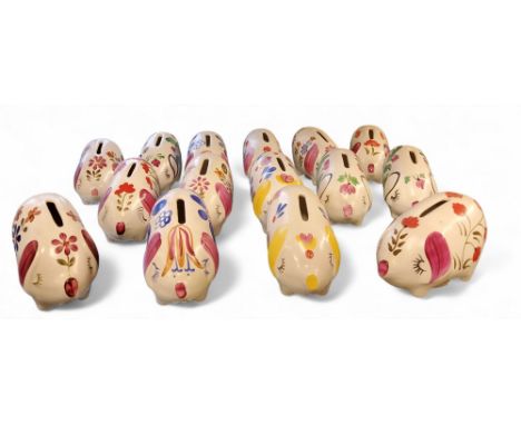 Fifteen&nbsp; Arthur Wood novelty money boxes, in the form of comical pigs, standing on all fours,&nbsp; painted with stylise