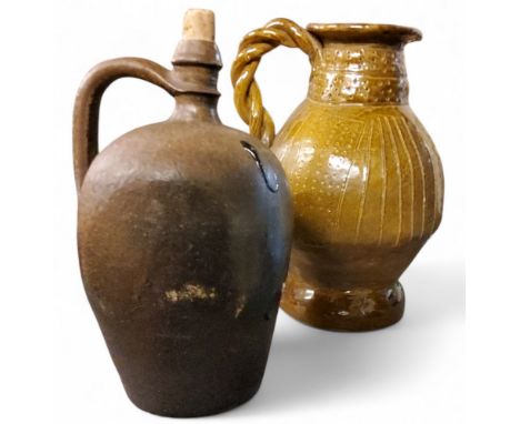 A 20th century stoneware ewer, incised in with lines and dots, twisted handle, 30cm high;&nbsp; another, German, late 19th ce