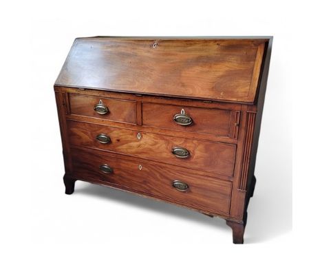 A George III mahogany bureau, the fall front above two short and three long drawers, fluted angles, high bracket feet, brass 