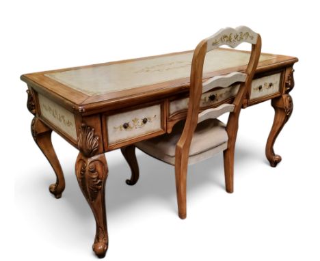 A contemporary French style desk, faux tooled leather inlaid writing surface, three drawers to frieze, bold acanthus capped c