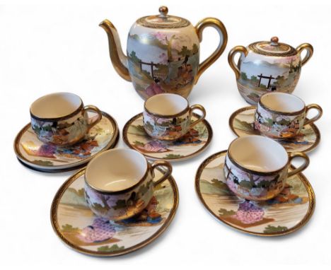 A Japanese satsuma tea&nbsp; service, comprising five cups, six saucers, teapot and two handled sucrier, in polychrome with f