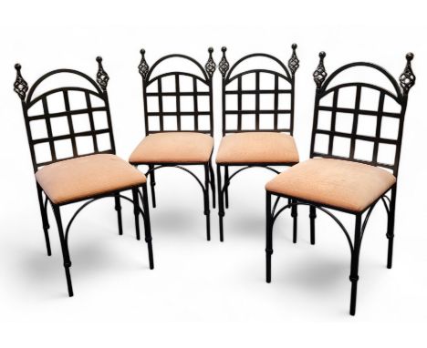 A set of four ebonised wrought iron chairs, open twisted finials, lattice workbook splat, arched apron, seat height 49cm