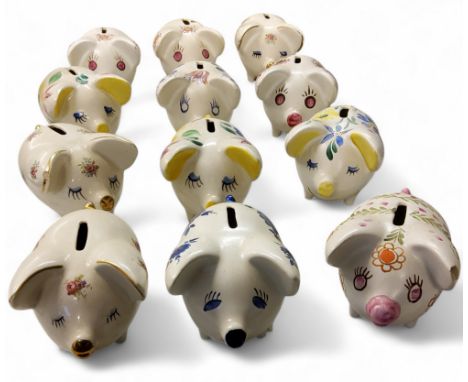 Twelve Arthur Wood novelty money boxes, in the form of comical pigs, standing on all fours, with large ears, painted with sty