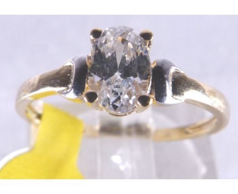 GOLD SOLITAIRE RING. 9 ct gold oval CZ solitaire ring, size J