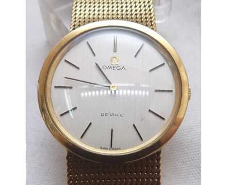 GENTS OMEGA DE VILLE WRISTWATCH. 9 ct gold gents Omega De Ville wristwatch with 9 ct gold strap, working at lotting up. CONDI