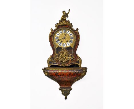 A 19th century Louis XIV style bracket clock and bracket. The red tortoiseshell boulle veneered case is embellished with bras