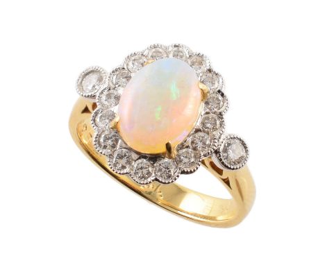 Opal and diamond oval cluster 18ct gold ring with diamond set shoulders , the oval cabochon cut opal measuring approx. 9mm x 