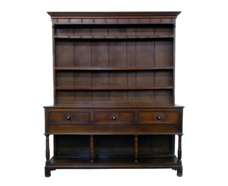 George III oak North Wales dresser, top section with original wire-work wrought hooks, three fixed shelves, base with three d