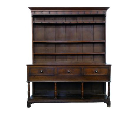 George III oak North Wales dresser, top section with original wire-work wrought hooks, three fixed shelves, base with three d