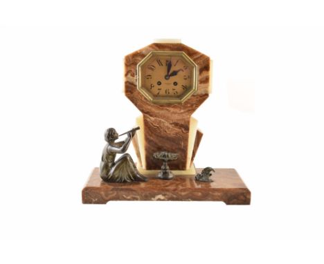 A marble Art Deco mantel clock. In a fanned octagonal form with contrasting cream and chestnut marble framing a brass dial wi