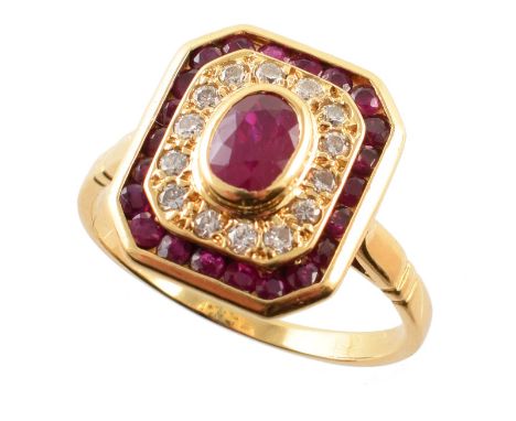 Ruby and diamond 18ct gold cluster ring , the central mixed cut oval ruby measuring approx. 4mm x 6mm, bezel set to octagonal