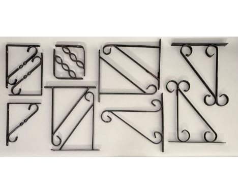 Seven triangular hanging basket brackets - of slightly varying scroll design, the hanging arms 29.5cm to 30.5cm long, steel w