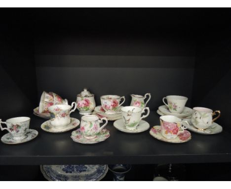 A shelf of cabinet cups and saucers including Royal Albert, Aynsley and Crown Staffordshire