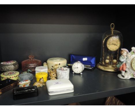 A miscellaneous shelf including a Schatz dome clock, trinket boxes etc