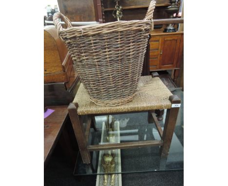 A wicker log basket and a seagrass top stool