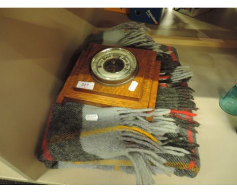 A mid 20th Century oak cased aneroid barometer and a travel rug