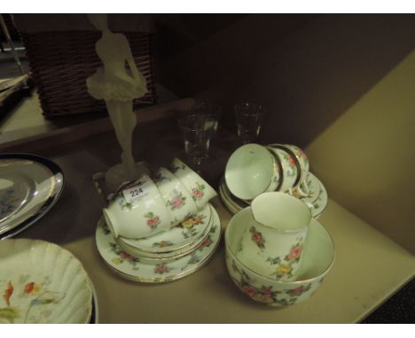 A vintage floral tea set, three sherry glasses and opaque resin ballerina