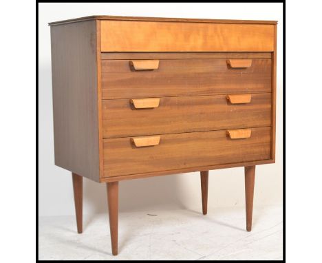 A retro 20th century, circa 1970's teak wood pedestal chest of drawers. Raised on shaped tapering legs with bank of central d
