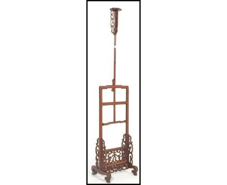 A vintage 20th century Chinese hardwood adjustable floor standing candlestick / lamp base having scrolled decoration with ban