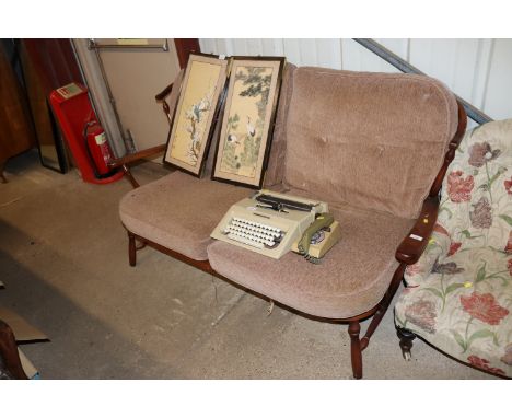 An Ercol stick back two seater settee