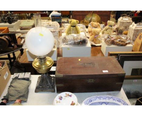 A Victorian mahogany writing box in need of restoration; and a brass oil lamp with cast iron base