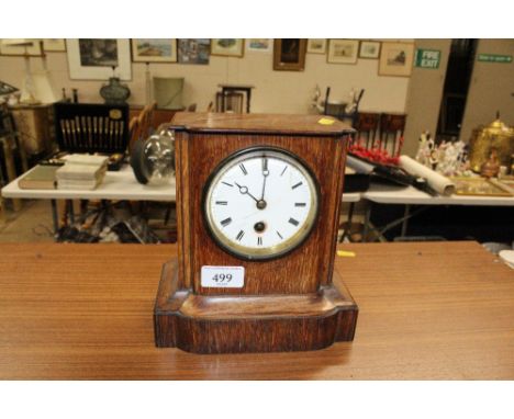 An oak cased single hole mantel clock 
