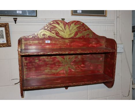 A painted and decorated wall shelf 