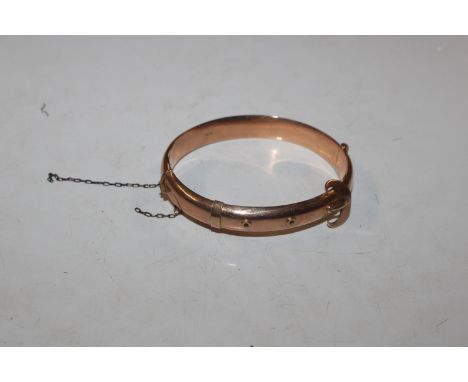 A 9ct gold snap bangle with buckle design, approx. 12.5gms