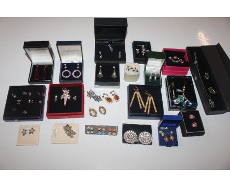 A box containing a large quantity of ear-rings and necklace and ear-ring sets