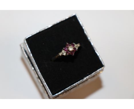 A yellow metal garnet and diamanté set ring