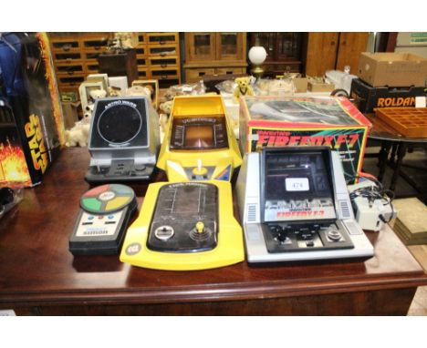 A quantity of vintage games to include Astro Wars, Grandstand Firefox F-7 with original box, Puck Monster and Frogger; and po