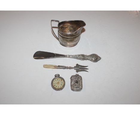 A silver cream jug, approx. 108gms; a vesta case; silver cased fob watch; a silver fork with mother of pearl handle and a sil