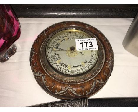 A barometer in round mahogany frame