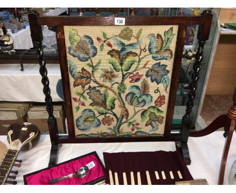 An oak framed tapestry fire screen