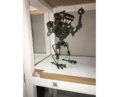 A sculpture of a robot made from motor parts