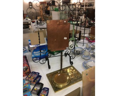 A wrought iron and hammered copper fire screen, brass warming pan and plaque