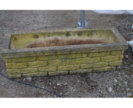 A RECTANGULAR COMPOSITE BRICK EFFECT GARDEN PLANTER, length 106cm x depth 37cm x height 29cm