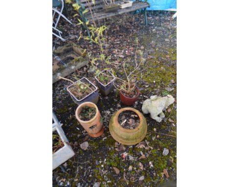 A TERRACOTTA URN SHAPED GARDEN PLANTER, a terracotta strawberry planter, a composite garden figure and three sized glazed gar