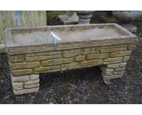 A RECTANGULAR COMPOSITE BRICK EFFECT GARDEN PLANTER, on matching separate supports, marked Sandford stone, length 76cm